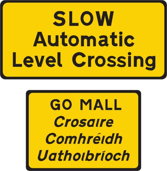 Yellow rectangular plates read SLOW Automatic Level Crossing, with Irish wording below.