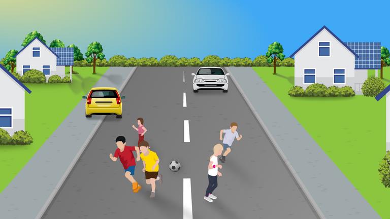 Residential road with groups of children near both sides of the road and cars farther ahead.