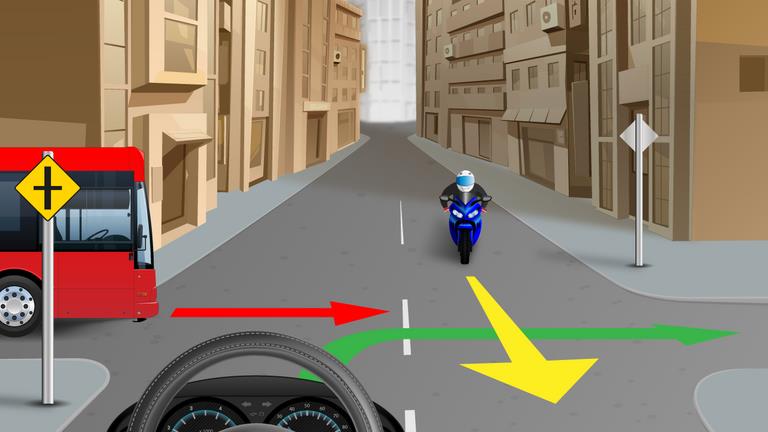 Driver's view at a crossroads with a red vehicle on the left and a motorcycle opposite; colored arrows cross the junction.