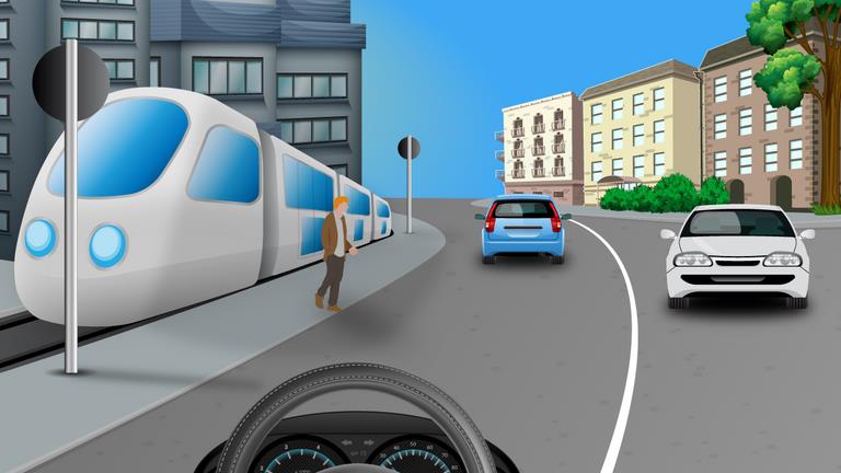 Driver's view of a tram beside the left pavement, a person beside it and cars ahead in the street.
