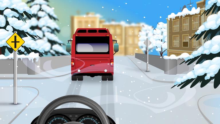 Driver's view following a red bus along a snow-covered street with snow-covered trees.