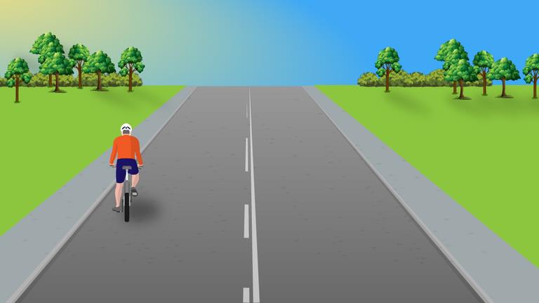 Cyclist ahead on the left side of a road with broken white center markings.