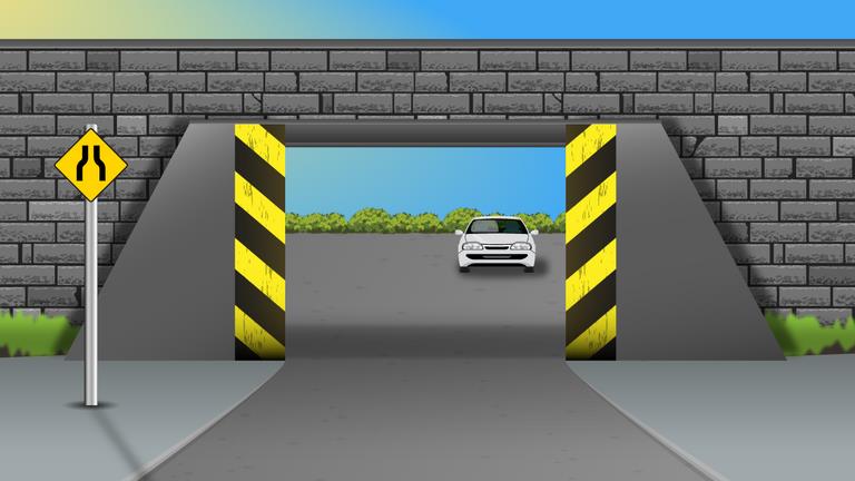 Low stone bridge over a road, black and yellow striped sides, a yellow sign to the left and a white car beyond.