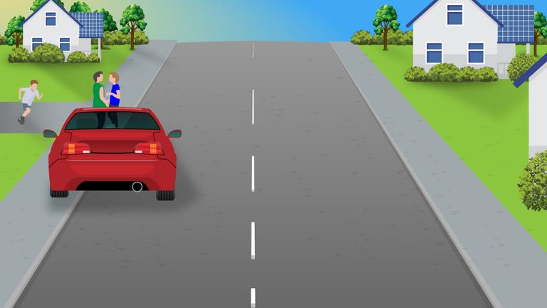 Red car ahead on a residential road, with people near its left side and houses beyond.