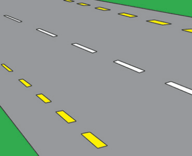 Road surface with broken white markings in the middle and broken yellow lines along the outer edges.