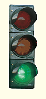 Vertical traffic light with the bottom green lamp illuminated.